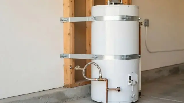 A tank water heater secured with metal straps to wall studs